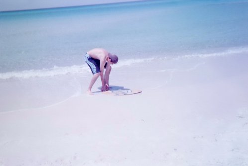 Joey carefully pulls the wakeboard from the sand.  If you did it too quickly, a stuck wakeboard could break in half.