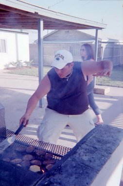 Rex shows off his skills as he flips burgers.