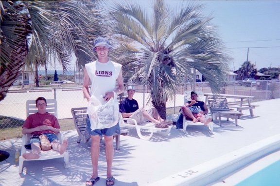 David, Phil, David, and Rex lounge by the pool