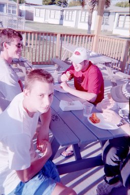 Daniel, Nate, Jon, and Mark are having a good time while they chow down on the good food.  Well, it looks as if at least Nate, Jon, and Mark are having a good time.